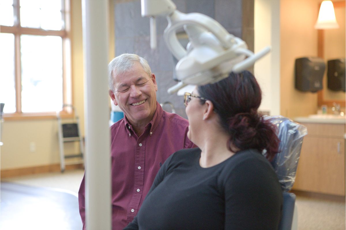 orthodontist-billings-mt-002 Dr. Thomas Kovacs engaging with a patient in a welcoming orthodontic office, emphasizing personalized care for braces and Invisalign in Billings, MT.